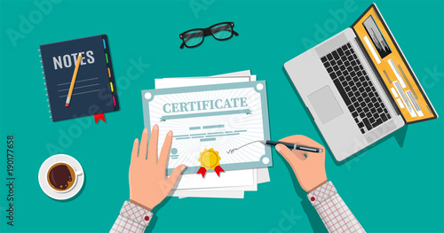 Businessman hand signs certificate.