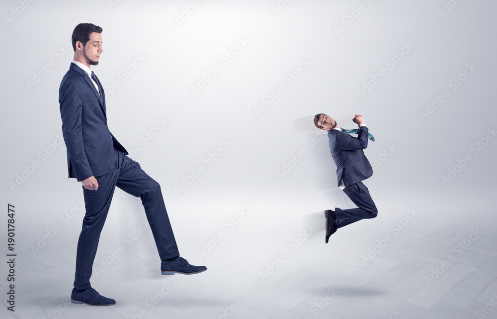 Fototapeta premium Small man fired by boss with white wallpaper