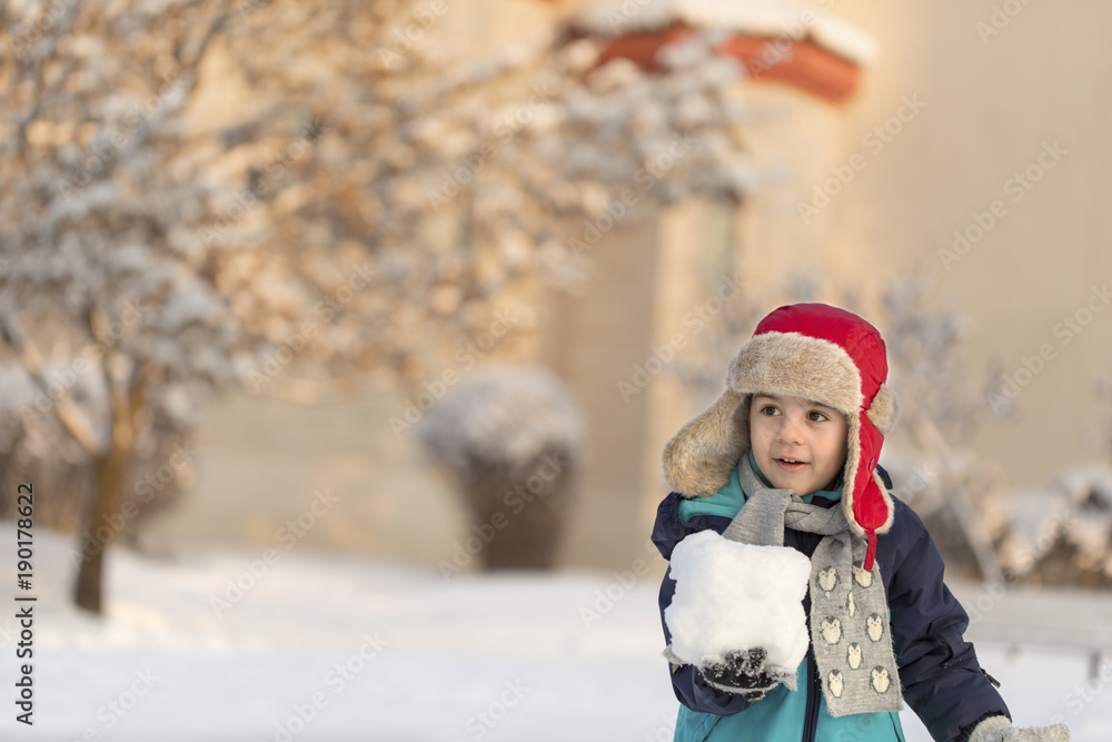 Young boy playing with snow outdoors Young boy playing with snow outdoors