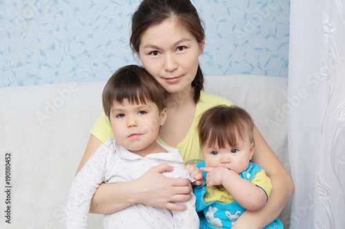Obraz na płótnie Mother with two daughters, multinational family with Asian mom and Caucasian lit