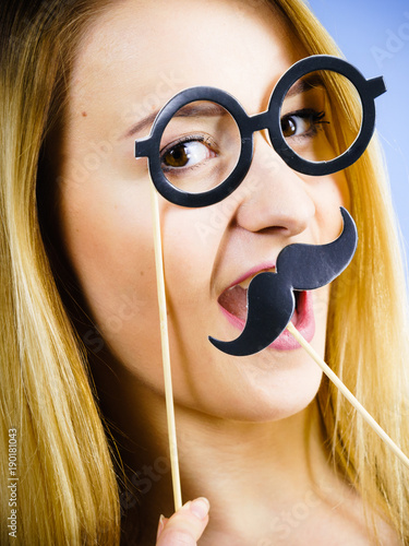 Woman holding carnival accessories on stick