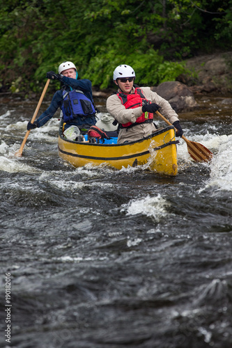 Group of people paddling the whitewater of the Noire River in Quebec, Canada.