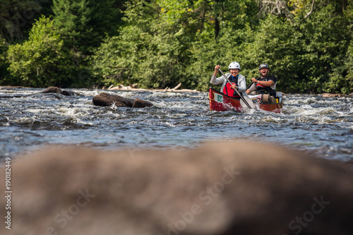 Obraz na płótnie Group of people paddling the whitewater of the Noire River in Quebec, Canada. w salonie