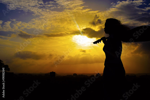Silhouette of girl with guitar, Pune