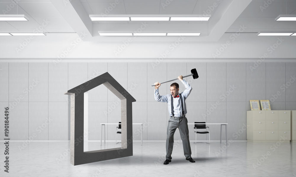 Stone home silhouette as symbol for real estate insurance crashed with man Stone home silhouette as symbol for real estate insurance crashed with man