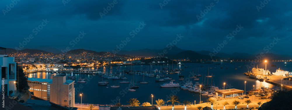 Mindelo in twilight. Port town with many boats in the bay on the Cape Verde in the northern part of the island Sao Vicente. Long exposure panoramic shot