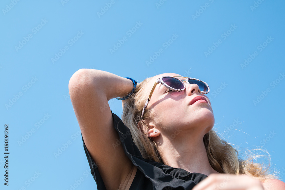 Portrait of blonde girl and blue sky on background Portrait of blonde girl and blue sky on background