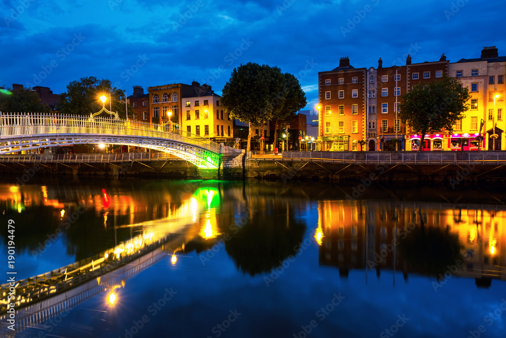 Morning view of famous illuminated Ha Penny Bridge in Dublin, Ireland