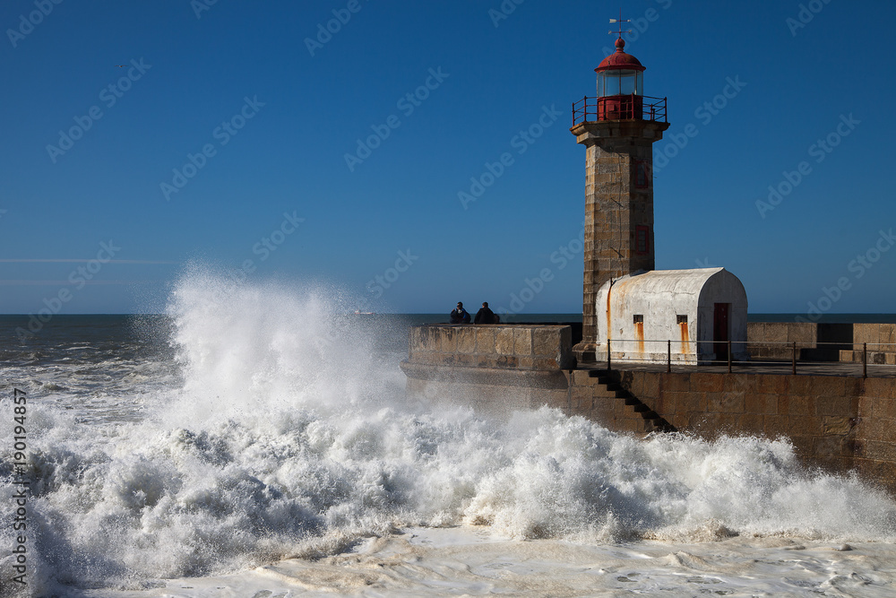 Atlantic wave breaking against mole in Porto, Portugal.