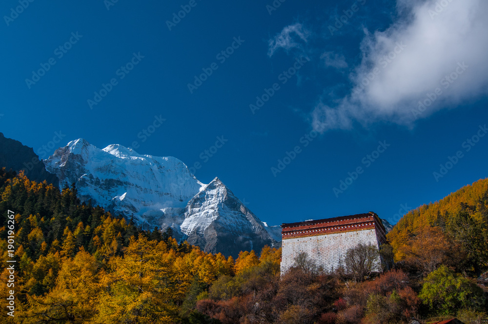 The Chonggu Monastery is the Temple in Yading Nature Reserve Daocheng Yading with the holy peak Xiannairi Peak (Chenresiq) can been seen in the background.
