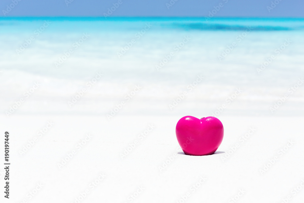 Fototapeta premium Valentines day concept greeting card, red heart on pristine sandy beach