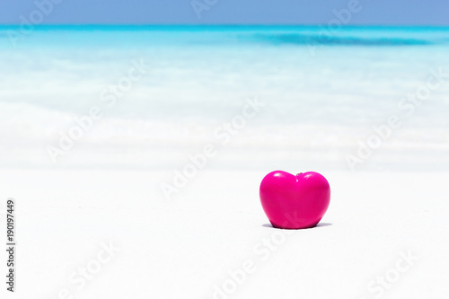 Valentines day concept greeting card, red heart on pristine sandy beach