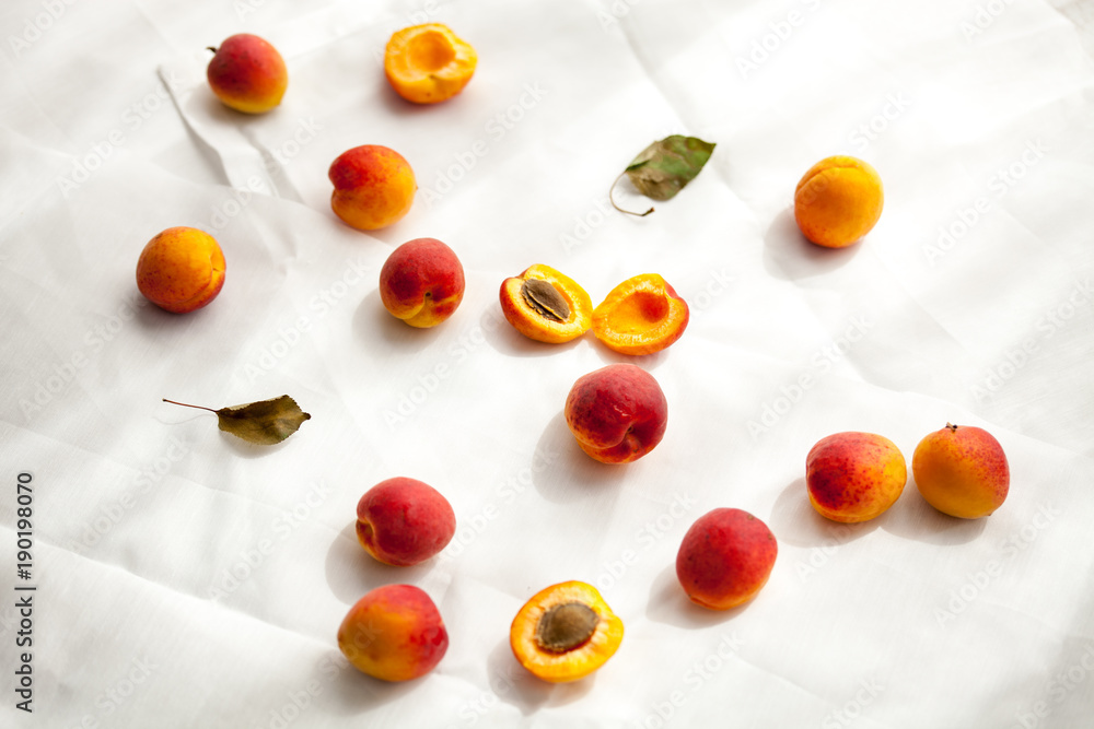 Apricots in paper bag, white background