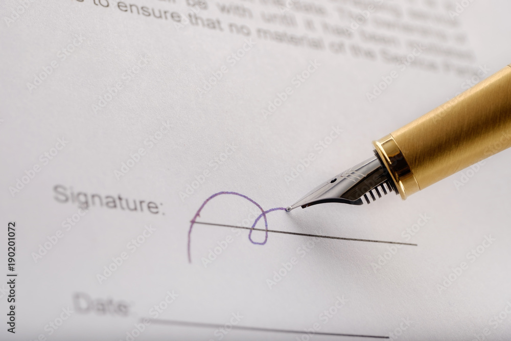 Someone with gilded fountain pen signing contract . Marco shot. Someone with gilded fountain pen signing contract . Marco shot.