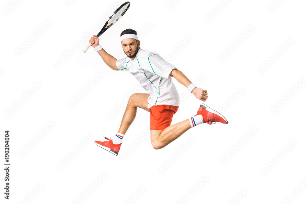 young sportsman jumping while playing tennis isolated on white