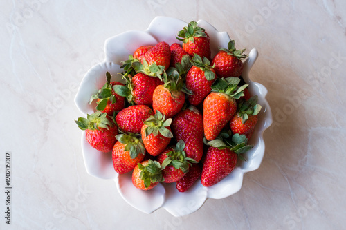Fresh Organic Ripe Strawberries in white Ceramic Bowl.