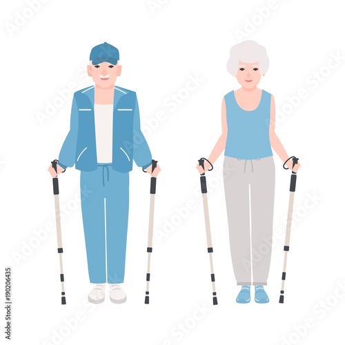 Pair of elderly men and women dressed in sports clothes performing nordic wal...