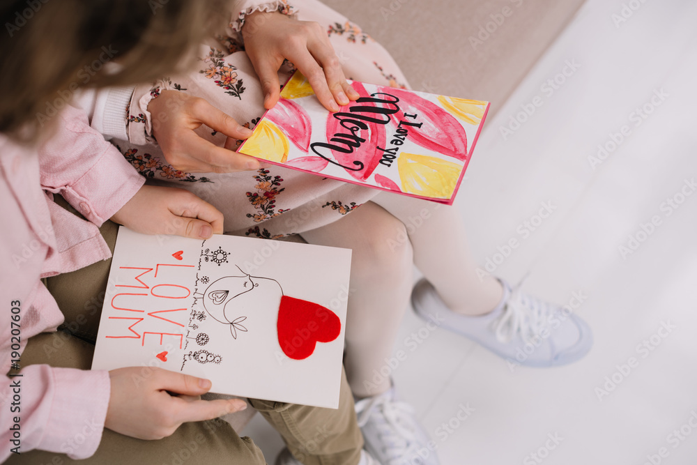 cropped shot of children with mothers day greeting cards sitting on couch at home cropped shot of children with mothers day greeting cards sitting on couch at home