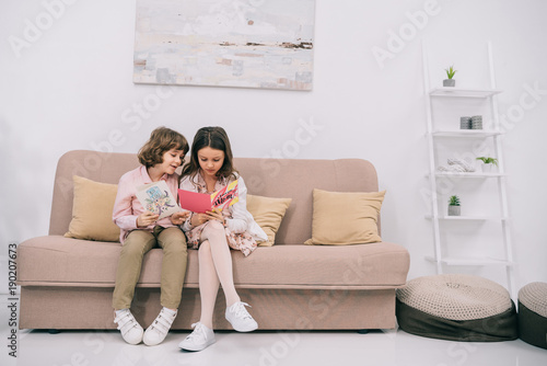 kids with mothers day greeting cards sitting on couch