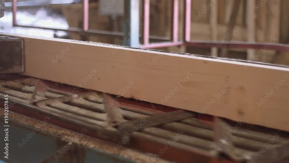 Wood plank cutted of log on woodworker machine at sawmill factory, sawdust, sunny day outside Wood plank cutted of log on woodworker machine at sawmill factory, sawdust, sunny day outside