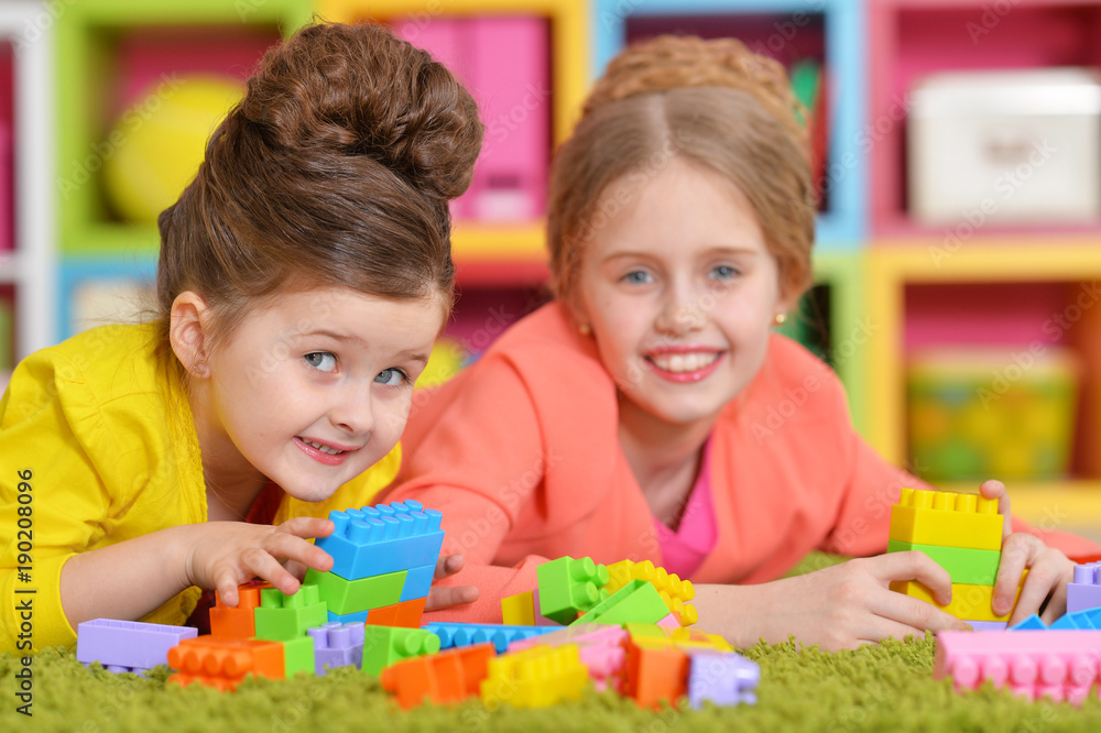 girls playing with colorful blocks girls playing with colorful blocks