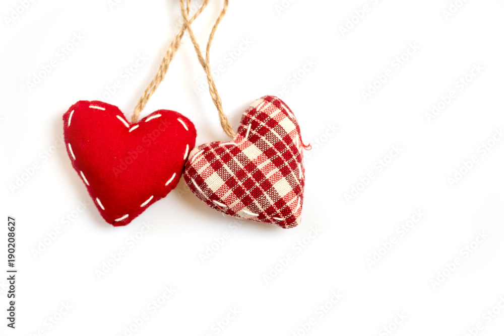 Two red fabric hearts on isolated on white background Two red fabric hearts on isolated on white background