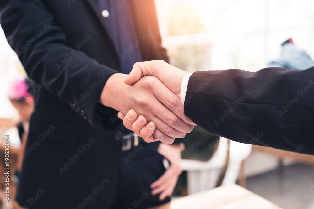 The abstract image of the businessman handshaking with another one during sunrise. The concept of agreement, business, cooperation, partnership and successful. The abstract image of the businessman handshaking with another one during sunrise. The concept of agreement, business, cooperation, partnership and successful.