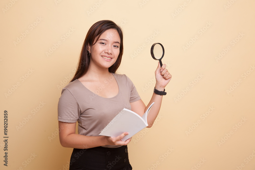 Asian woman with a book and magnifying glass. Asian woman with a book and magnifying glass.