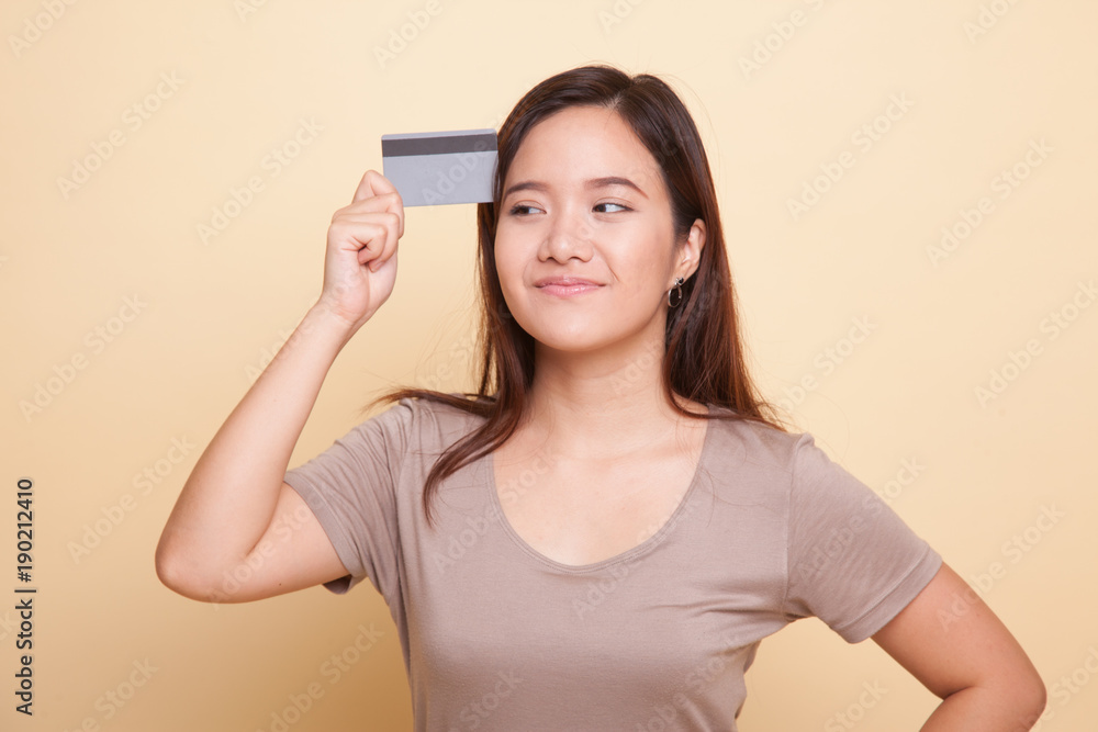 Young Asian woman think with a blank card. Young Asian woman think with a blank card.