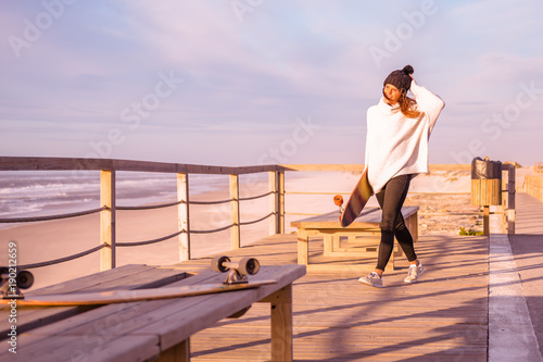 Girl holding a skateboard