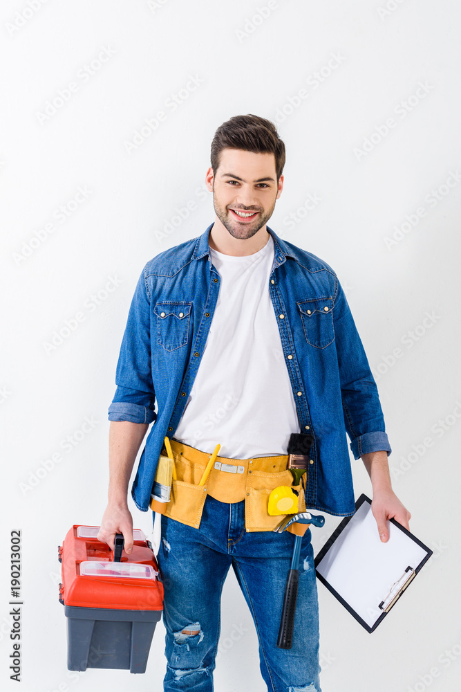 smiling handsome worker with tools box and clipboard smiling handsome worker with tools box and clipboard