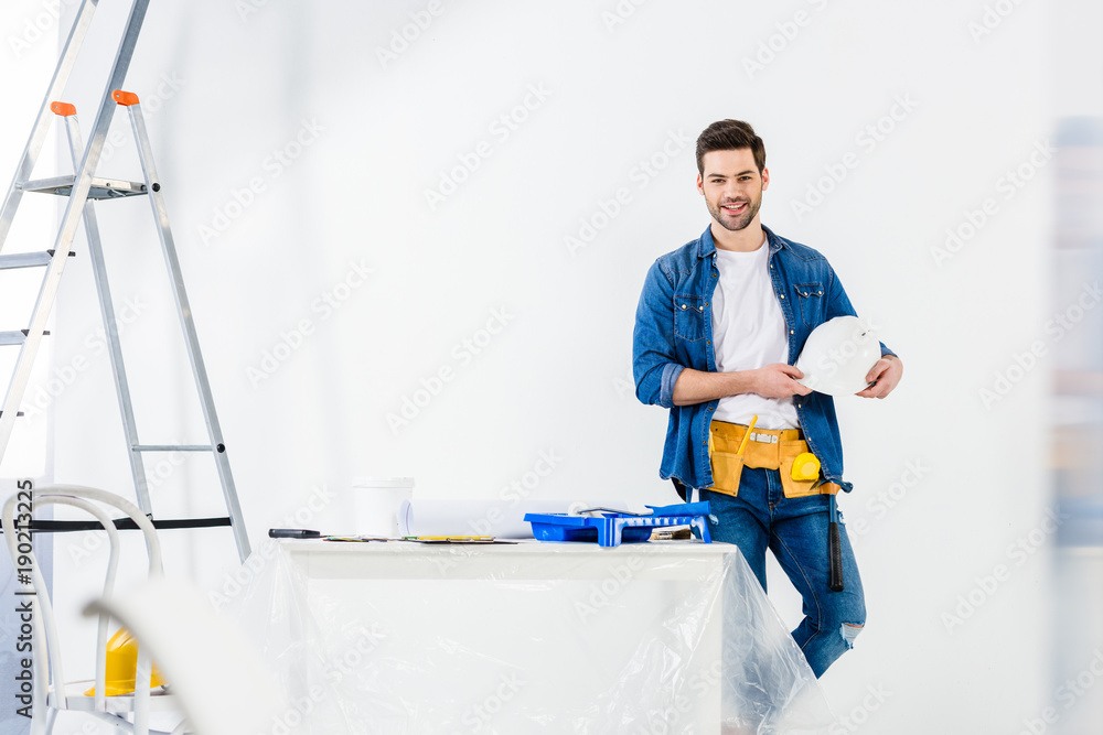 smiling handsome worker standing with helmet smiling handsome worker standing with helmet