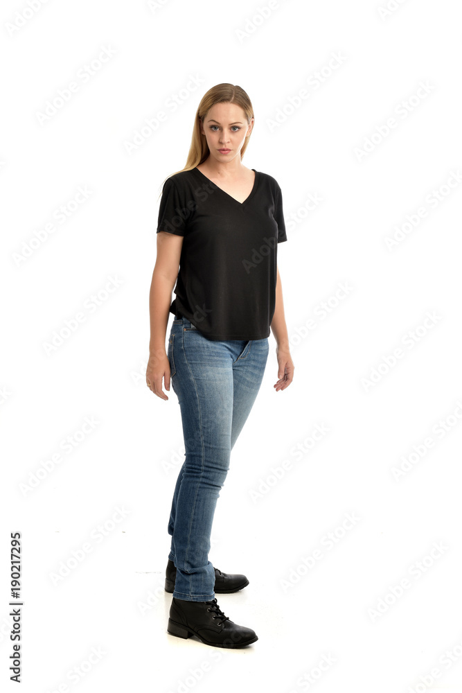 full length portrait of blonde girl wearing black shirt and jeans ...