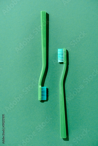 top view of green toothbrushes  on green