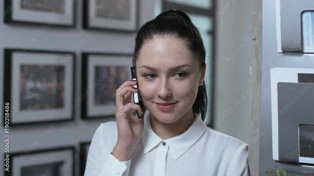 Young Businesswoman Starting a Phone Call Indoors Young Businesswoman Starting a Phone Call Indoors