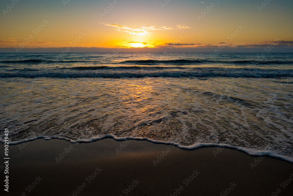  sunset or sunrise on the sea with a sandy beach. Calm sea at dusk