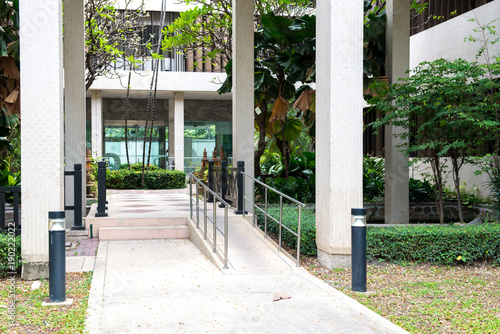 front side of ramp way to support wheelchair disabled people infront of the office building photo