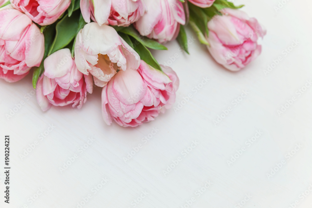 Bouquet of pink tulips over shabby white wooden table. Spring greeting card happy mother day copy space Bouquet of pink tulips over shabby white wooden table. Spring greeting card happy mother day copy space