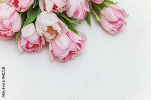 Bouquet of pink tulips over shabby white wooden table. Spring greeting card happy mother day copy space