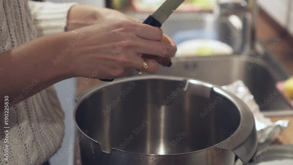 Woman preparing egg for baking cake at home Woman preparing egg for baking cake at home