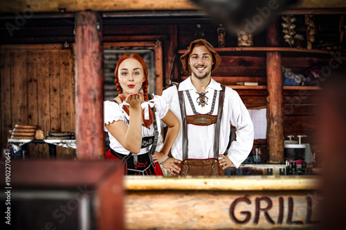 Young bavarian people and their own small business. Grill bar interior. 