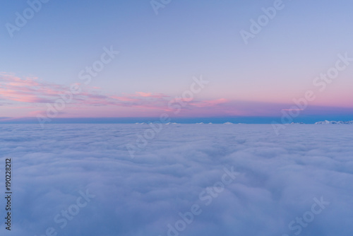 Beautiful sunset above clouds in snow covered Low Tatras mountains during susnet in winter