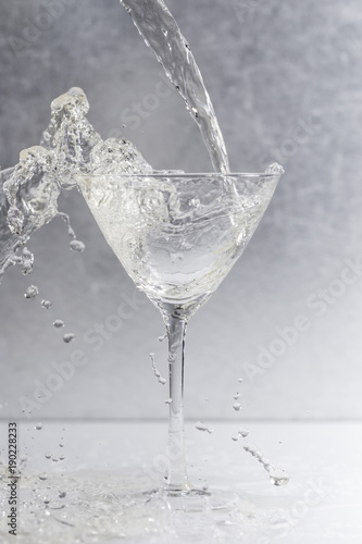liquid pouring into a cocktail glass
