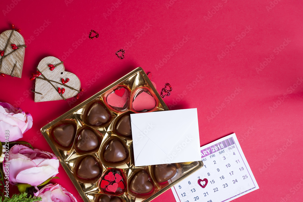 Delicious chocolate candies in gift box on red background Delicious chocolate candies in gift box on red background