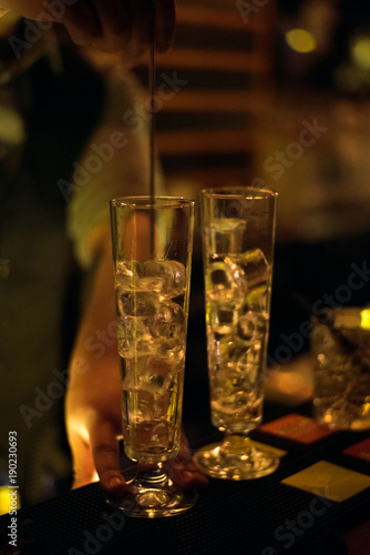 Alcohol bar, cocktail glass on bar counter, cocktail glass in a bar, Drinking cocktail in bar, cocktail in the glass with straws, Fresh drink coctail on a color background