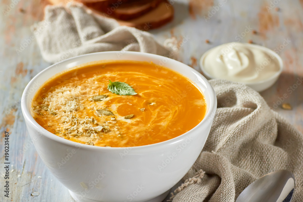Bowl of pumpkin soup with cheese and cream Bowl of pumpkin soup with cheese and cream