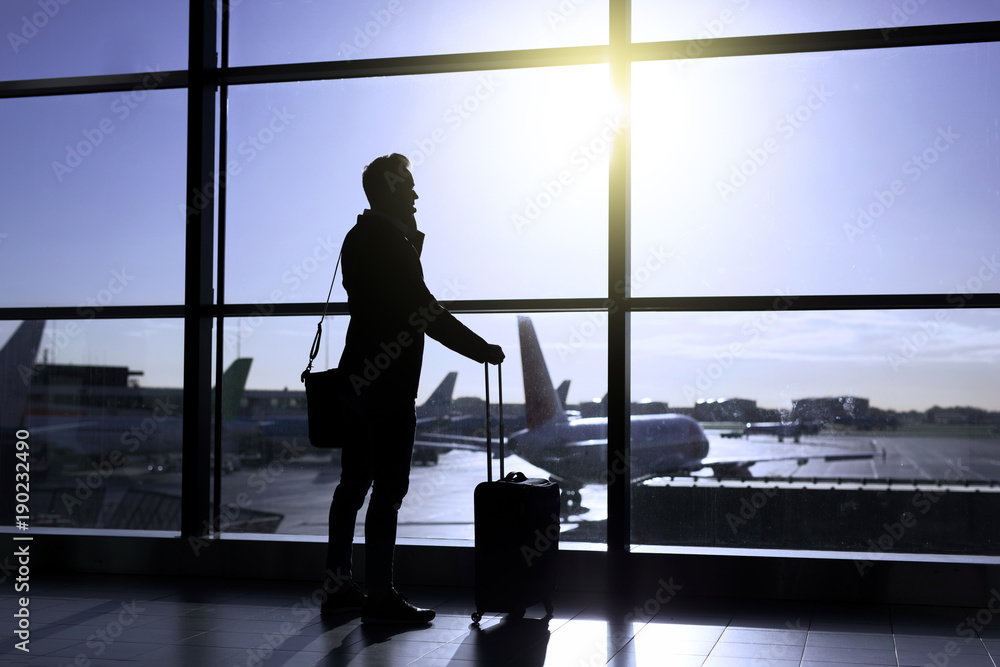 Businessman standing in airport Businessman standing in airport
