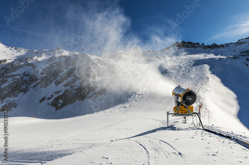 snowmaking - snow cannon working on the slope photo