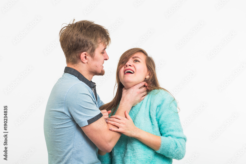 Woman victim of domestic violence and abuse. The quarrel in the family. A man beats a young woman on white background Woman victim of domestic violence and abuse. The quarrel in the family. A man beats a young woman on white background