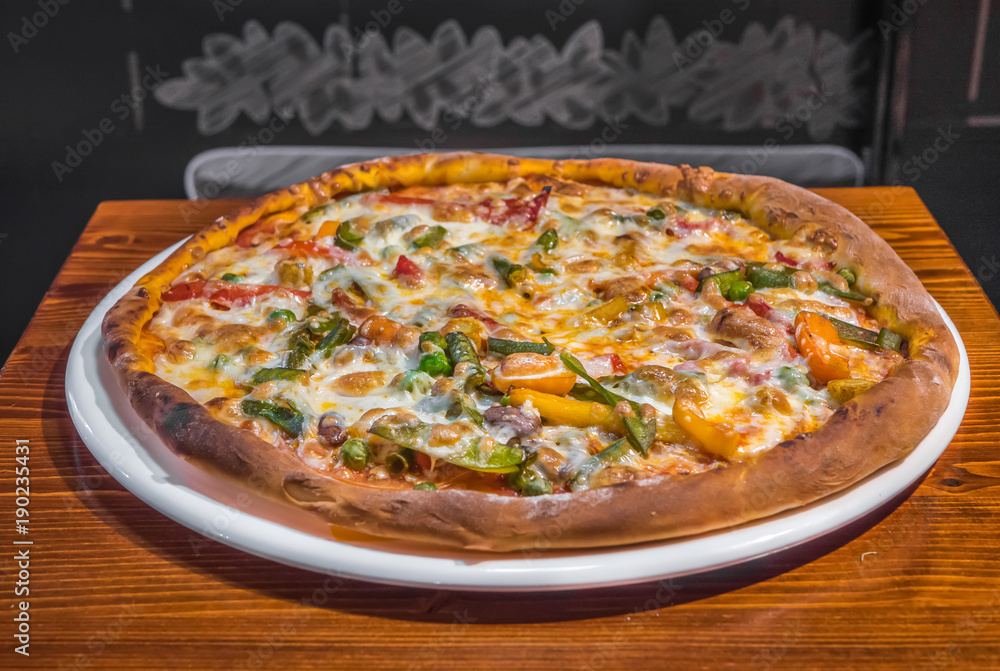 Hot delicious pizza freshly cooked in a cafe Hot delicious pizza freshly cooked in a cafe
